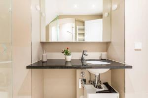 a bathroom with a sink and a mirror at Berlin Mitte I 2 doule beds I fast wifi in Berlin +17 photos