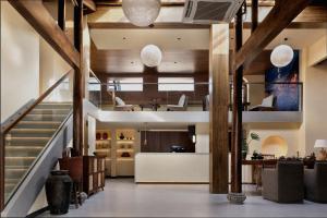 a lobby with a staircase and a living room at Hongcun Nanhu Guanyuan Designer Lake View Resort Hotel Scenic spot tickets are not included in Huangshan Scenic Area