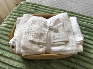 a white towel with a bow on a bed at Ti porto al mare - Luxury & Relax in Siracusa +71 photos