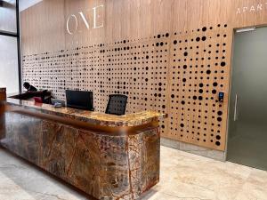a lobby with a desk with a laptop on it at Modern Luxury 1 bed apartment in Johannesburg