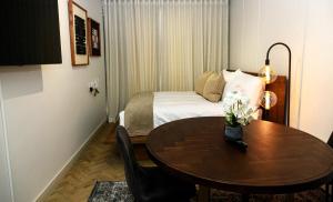 a hotel room with a table and a bed at Modern Luxury 1 bed apartment in Johannesburg +18 photos