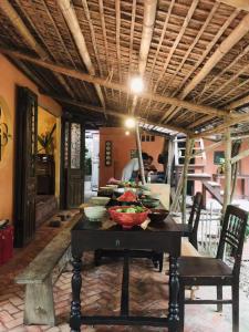a dining room table with bowls of food on it at Yên homestay in Hoi An