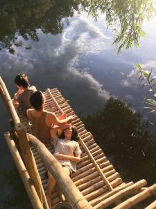 a group of people sitting on a raft in the water at Yên homestay in Hoi An