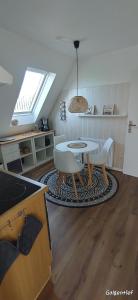 a kitchen with a table and chairs in a room at Uns Lüttje in Norden +8 photos