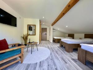 a hotel room with two beds and a tv at Apartment Anur in Bihać