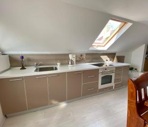 a kitchen with a sink and a stove and a window at Mini Vacanta La Munte in Zărneşti