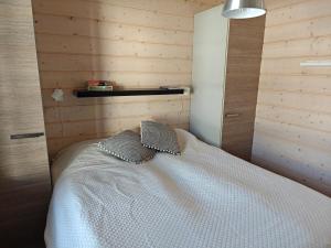a bedroom with a bed with two pillows on it at Vutnusmaja air-conditioned holiday home at Iso-Syöte in Syöte +9 photos