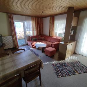 a living room with a couch and a table at Haus Maria Bodensdorf in Tratten