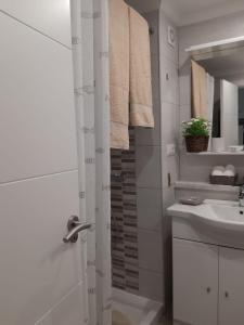 a white bathroom with a sink and a shower at Jose Carlos in Puerto de la Cruz +9 photos