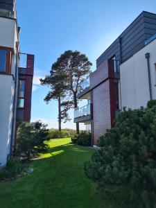 an exterior view of a house with a yard at Apartament Mestwina 54 Jurata in Jurata