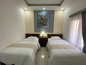 Postel nebo postele na pokoji v ubytování Bidadari Homestay Nusa Dua