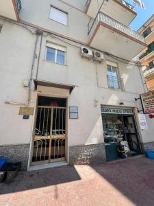 a building with a door in front of a store at La Casa di Armando in Agrigento