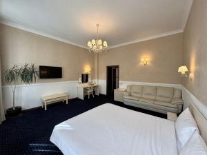 a hotel room with a bed and a couch at Odeska Astoria in Odesa