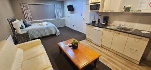 a room with a kitchen and a living room at C'est La Vie in Tauranga
