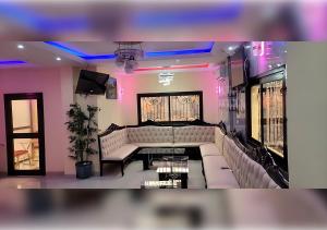 a living room with a couch and a table at NEFAR PALACE HOTEL Plc in Bafoussam