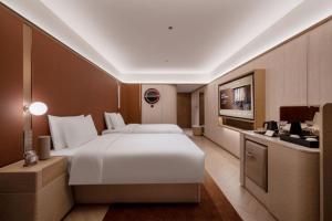Katil atau katil-katil dalam bilik di Orange Crystal Hotel MixC Shantou East Coast
