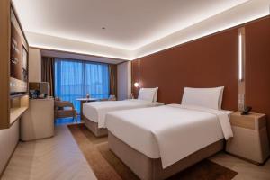 Katil atau katil-katil dalam bilik di Orange Crystal Hotel MixC Shantou East Coast
