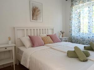 a bedroom with two beds and a window at Apartment Daisy in Vantačići