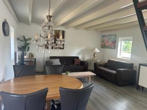 a living room with a table and a couch at Zonneoord in Ede
