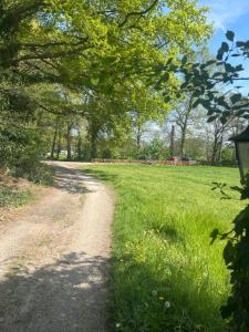 a dirt road through a field with trees at Zonneoord in Ede