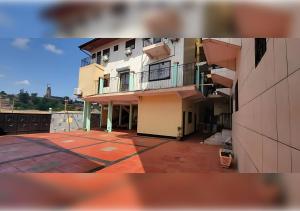 a view of a building with a balcony at NEFAR PALACE HOTEL Plc in Bafoussam
