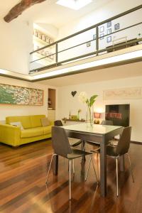 a dining room and living room with a table and chairs at The Star Loft - A Luxury top floor in Como