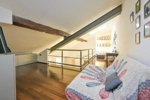 a living room with a couch and a staircase at The Star Loft - A Luxury top floor in Como