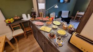 a kitchen with a counter with food on it at Vila Koman Jezersko in Zgornje Jezersko