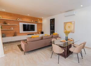 a living room with a couch and a table at La villa Socé in Saly Portudal