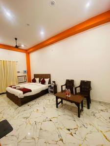 a hotel room with a bed and a table at Hotel Laxmanam Residency - 900 meters from Shree Ram Temple Ayodhya in Ayodhya