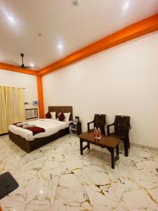 a hotel room with a bed and a table at Hotel Laxmanam Residency - 900 meters from Shree Ram Temple Ayodhya in Ayodhya
