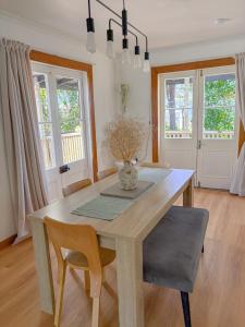 a dining room with a wooden table and chairs at Willow & Waves- Huge outdoor space & Full kitchen in Hector
