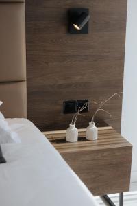 a bedroom with a bed and a table with a lamp at Odysseia Hotel Kapetanios in Limassol