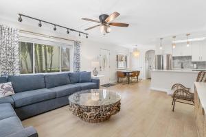 a living room with a blue couch and a table at Palm Cay 5 in Holmes Beach
