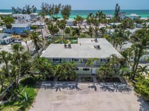 an aerial view of a building with palm trees and the ocean at Palm Cay 5 in Holmes Beach