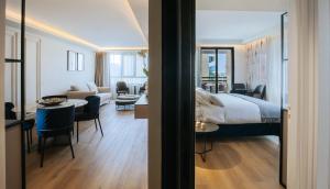 a hotel room with a bed and a living room at Odysseia Hotel Kapetanios in Limassol