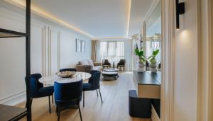 a living room with a table and chairs at Odysseia Hotel Kapetanios in Limassol