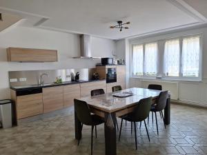 a kitchen with a table and chairs in a room at 7Cépages in Vertus +14 photos