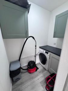 a laundry room with a washing machine and a sink at Helensburgh Central Apartment - Macaulay Letting in Helensburgh