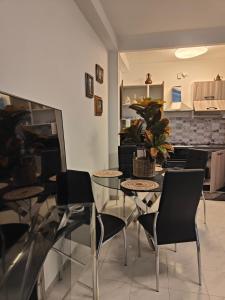 a dining room with a table and chairs and a kitchen at riva vacanze in Riva Ligure