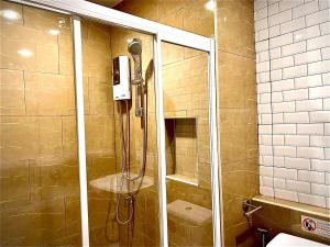 a shower in a bathroom with a glass door at The Circle 4 in Bangkok +29 photos