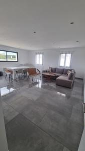 a living room with a couch and a table at Villa familliale Mornas 4 chambres in Mornas