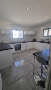 a large kitchen with a table and a stove at Villa familliale Mornas 4 chambres in Mornas +9 photos