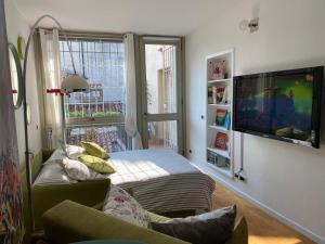 a living room with a couch and a flat screen tv at La Casetta sui tetti in Bergamo