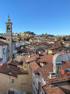 a view of a city with a clock tower at La Casetta sui tetti in Bergamo