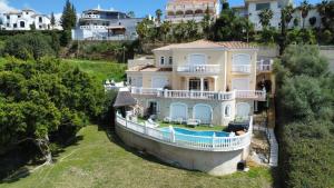 an aerial view of a house with a boat at Casa Darcey in Mijas