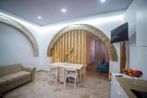 a living room with a table and a couch at Molise Garden Apartments Renato in Boiano