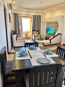 a living room with a table with chairs and a living room at Stunning beachfront 2 bedroom apartment in Mombasa +21 photos