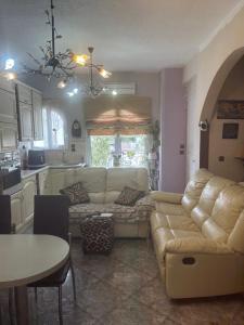 a living room with a couch and a table at Mandy's cosy luxury flat in Piraeus