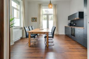 a kitchen with a wooden table and chairs at Erdgeschoss Wohnung in der City in Walsrode